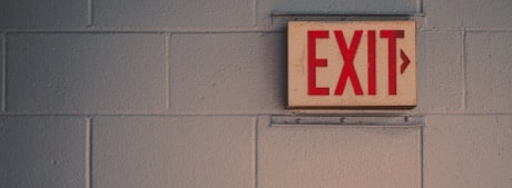 An exit sign hanging on a wall.